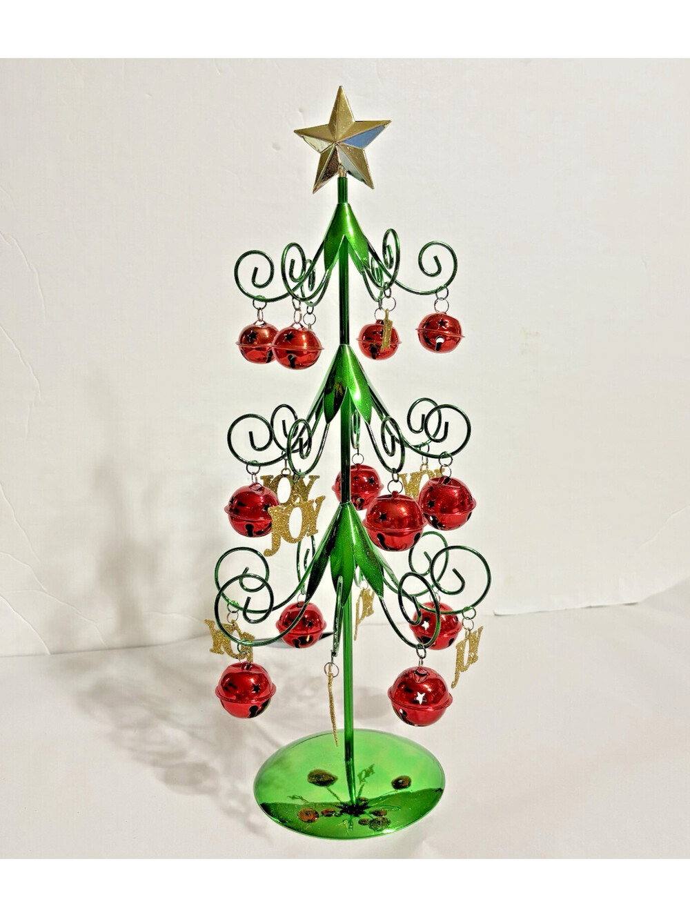Green Metal Decorated Christmas Table Tree With Red Bells and Gold Joy Dangles